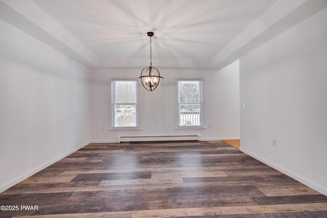 unfurnished room with a raised ceiling, dark hardwood / wood-style flooring, a chandelier, and baseboard heating