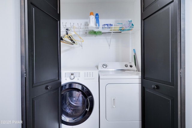 clothes washing area featuring washer and dryer