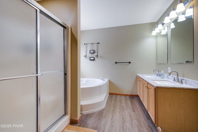 bathroom with vanity, shower with separate bathtub, and hardwood / wood-style floors