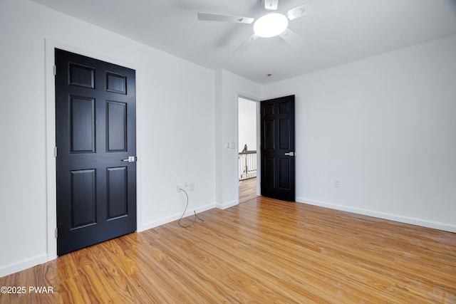 empty room featuring ceiling fan and light wood-type flooring