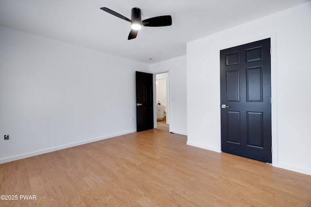 spare room with ceiling fan and light wood-type flooring