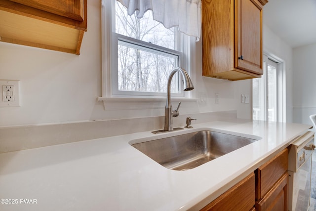 kitchen featuring white dishwasher and sink