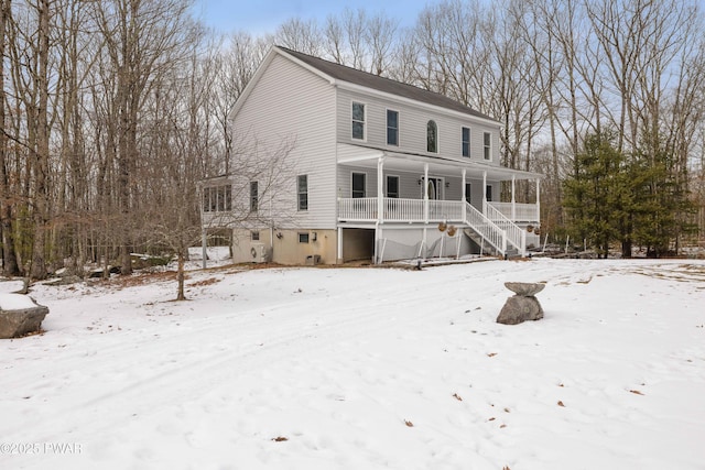 snow covered property featuring a porch