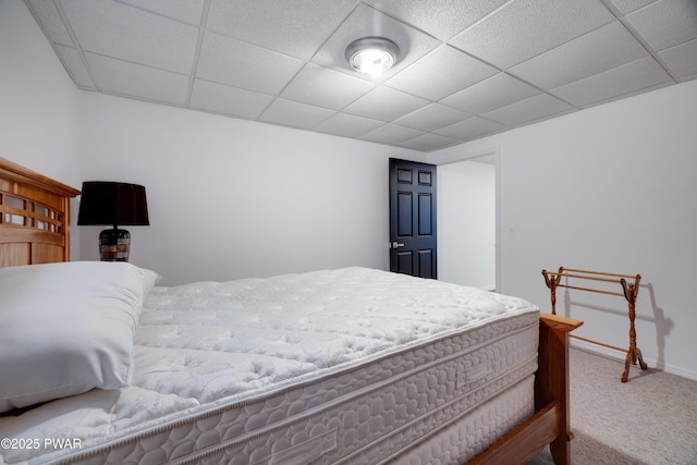 carpeted bedroom featuring a paneled ceiling