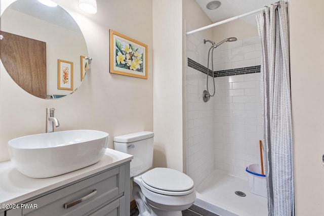 bathroom with vanity, toilet, and walk in shower