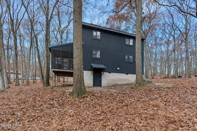 rear view of property featuring a sunroom