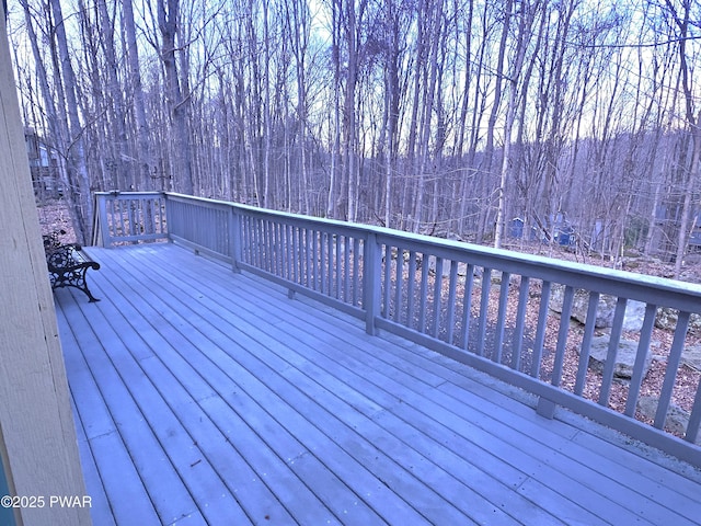 wooden terrace with a forest view