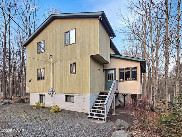 view of side of home featuring stairway
