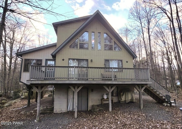 back of house featuring stairway and a wooden deck