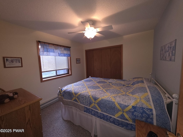 carpeted bedroom with a closet, ceiling fan, a textured ceiling, and baseboard heating