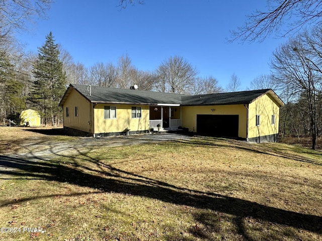 single story home featuring a garage and a front yard