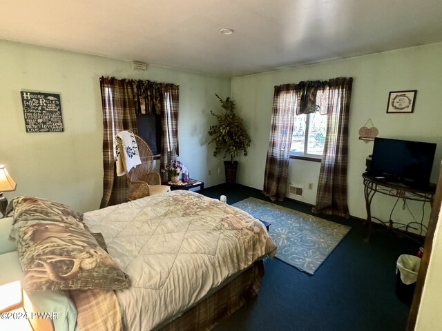 bedroom featuring dark carpet