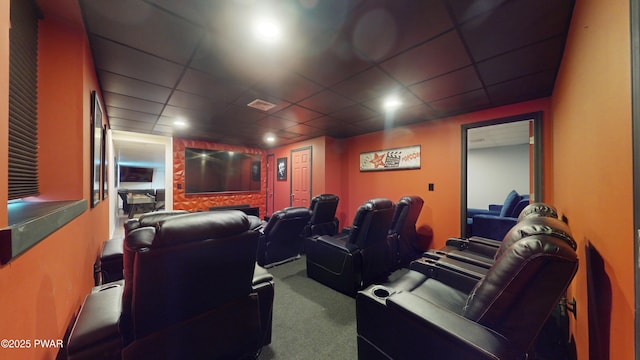 cinema room featuring carpet floors and a paneled ceiling