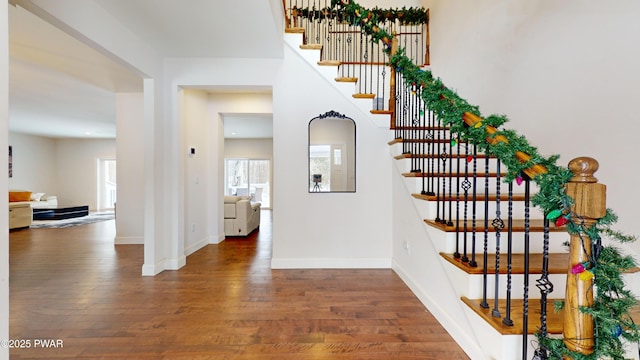 stairs featuring hardwood / wood-style flooring