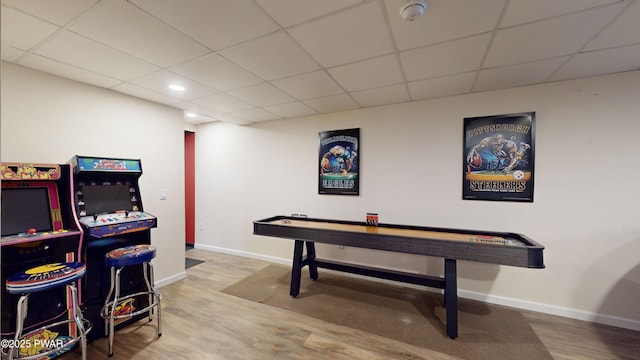 game room with hardwood / wood-style floors and a drop ceiling