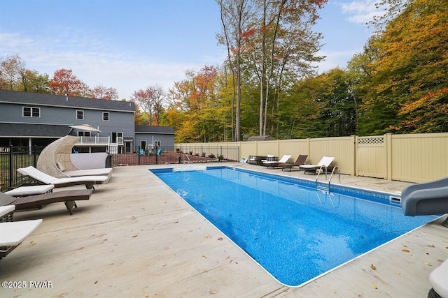 view of swimming pool with a water slide