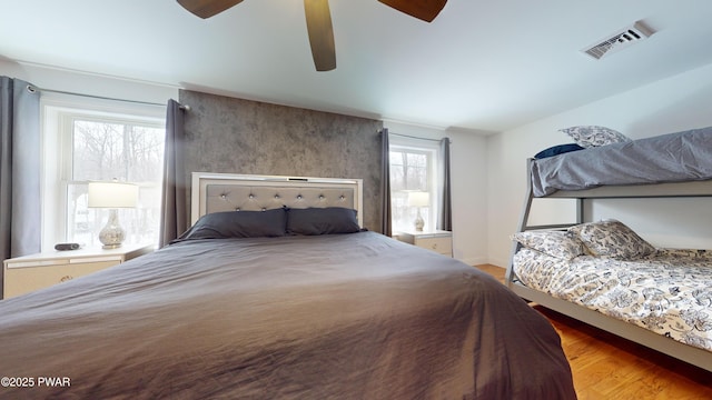 bedroom with ceiling fan and light hardwood / wood-style flooring