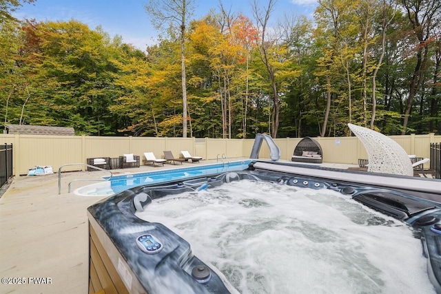 view of pool featuring a jacuzzi