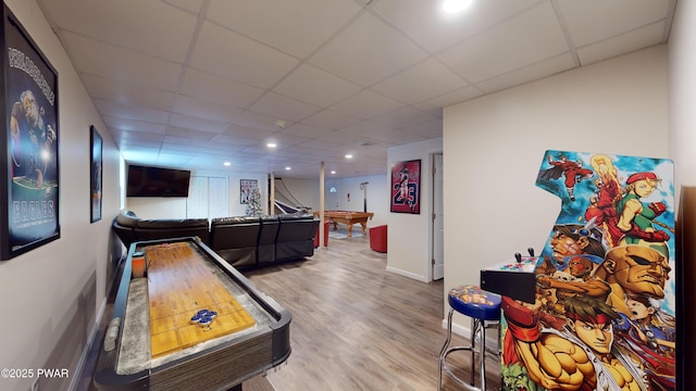 recreation room with hardwood / wood-style flooring and a drop ceiling