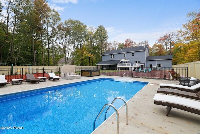 view of swimming pool with a jacuzzi and a patio