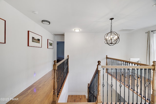 hall featuring a chandelier and light wood-type flooring