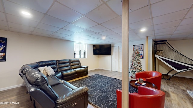 living room featuring a paneled ceiling and hardwood / wood-style floors