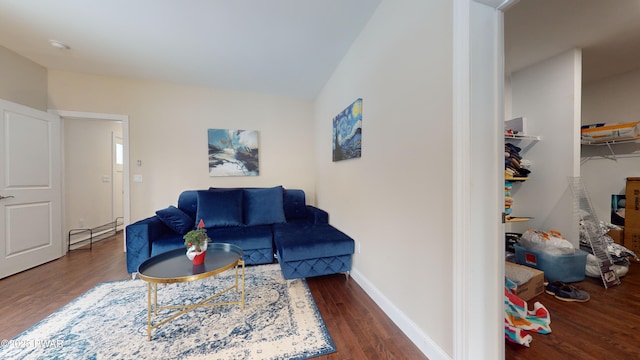 living room with a baseboard radiator and dark wood-type flooring