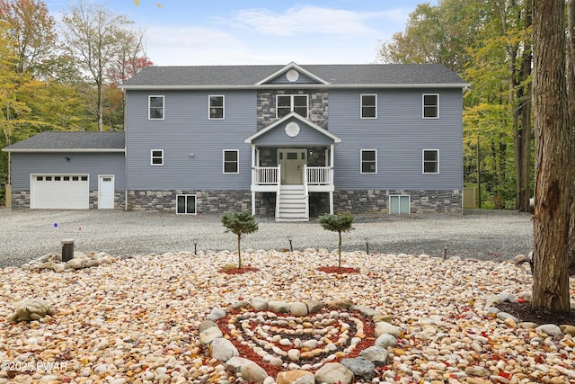 view of front facade with a garage and a porch