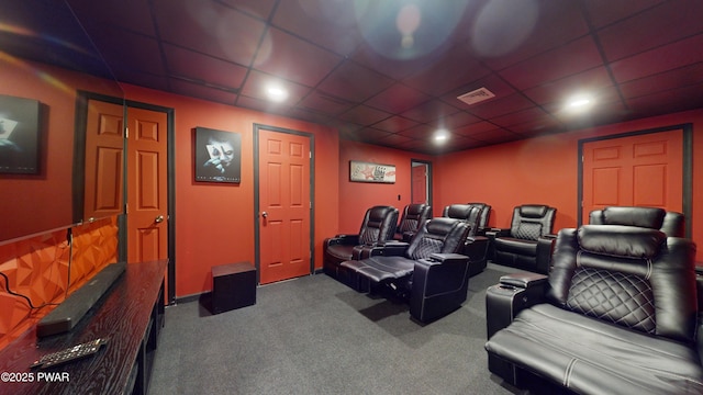 cinema room featuring a paneled ceiling and carpet flooring