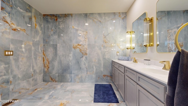 bathroom featuring vanity and tile walls