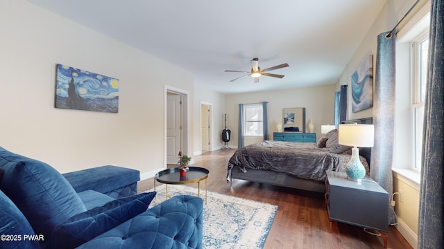 bedroom with dark hardwood / wood-style floors and ceiling fan