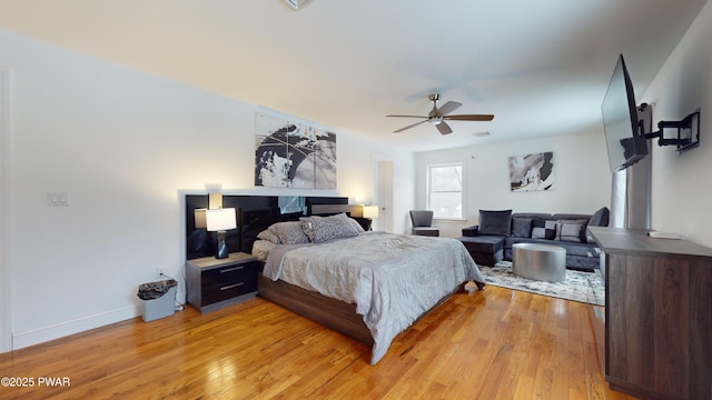 bedroom with ceiling fan and light hardwood / wood-style floors