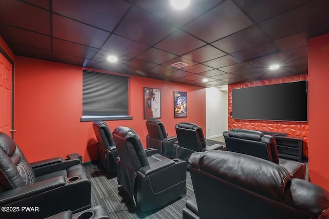 home theater featuring a paneled ceiling and carpet