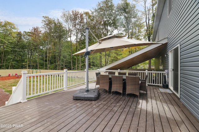 wooden deck with a lawn