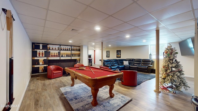 rec room featuring wood-type flooring, bar, a drop ceiling, and billiards