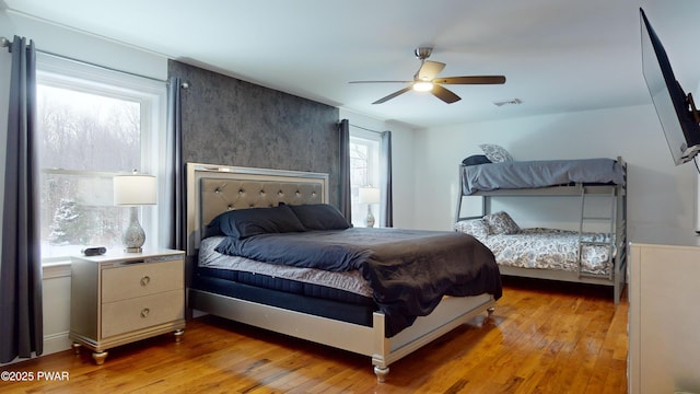 bedroom with light hardwood / wood-style flooring and ceiling fan