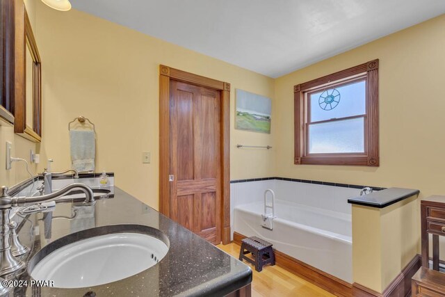 517 Sherman Rd, Susquehanna, PA 18847 - full bathroom with vanity, a bath, and wood finished floors