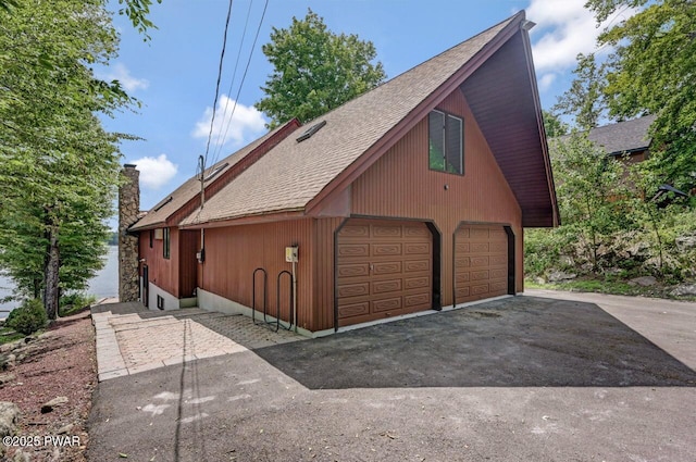 518 Lakeview Dr E, Lake Ariel, PA 18436 - view of front of home featuring roof with shingles, a detached garage, and a chimney