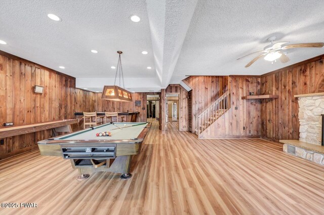 518 Lakeview Dr E, Lake Ariel, PA 18436 - rec room featuring wooden walls, a textured ceiling, wood finished floors, pool table, and a stone fireplace