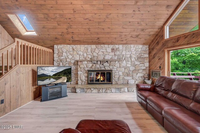 518 Lakeview Dr E, Lake Ariel, PA 18436 - living room featuring wooden walls, a skylight, wood ceiling, wood finished floors, and high vaulted ceiling