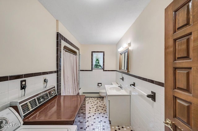 518 Lakeview Dr E, Lake Ariel, PA 18436 - full bathroom featuring tile walls, a baseboard heating unit, vanity, curtained shower, and a wainscoted wall