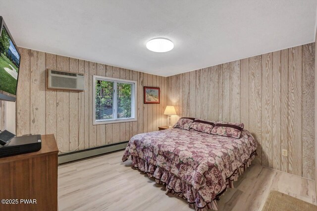 518 Lakeview Dr E, Lake Ariel, PA 18436 - bedroom featuring a baseboard heating unit, wood finished floors, wood walls, and an AC wall unit