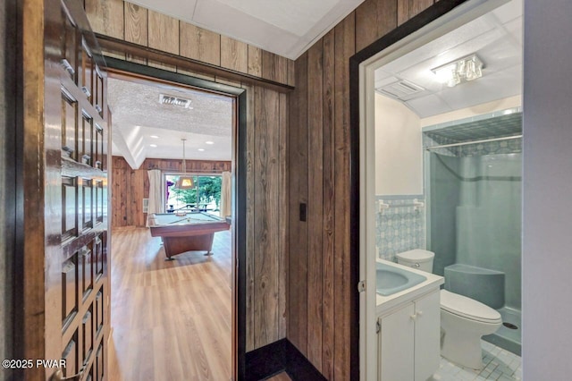 518 Lakeview Dr E, Lake Ariel, PA 18436 - full bathroom with vanity, a shower, wood walls, pool table, and wood finished floors