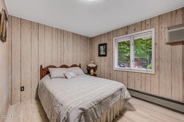518 Lakeview Dr E, Lake Ariel, PA 18436 - bedroom with a baseboard heating unit, light wood finished floors, wooden walls, and a wall mounted air conditioner
