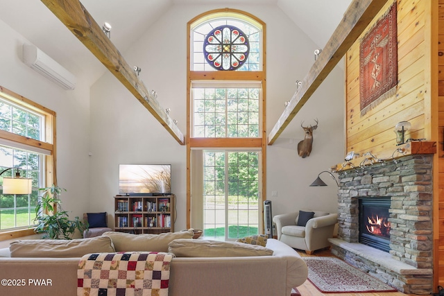 58 Rude Rd, Waymart, PA 18472 - living room featuring high vaulted ceiling, a wall unit AC, a fireplace, and wood finished floors
