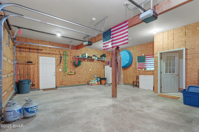 58 Rude Rd, Waymart, PA 18472 - garage with a garage door opener and freestanding refrigerator