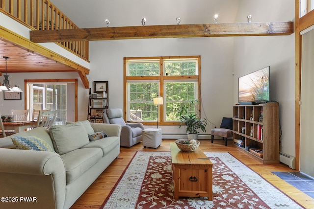 58 Rude Rd, Waymart, PA 18472 - living room featuring plenty of natural light, light wood-style floors, a baseboard heating unit, and beam ceiling