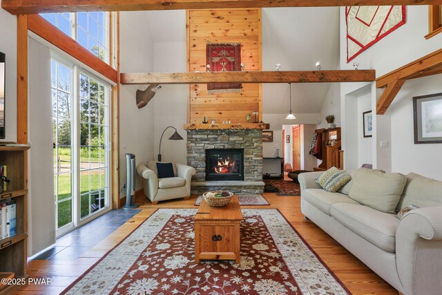 58 Rude Rd, Waymart, PA 18472 - living room with high vaulted ceiling, healthy amount of natural light, wood finished floors, and a stone fireplace