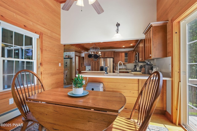 58 Rude Rd, Waymart, PA 18472 - dining area with wooden walls, a chandelier, light wood-type flooring, and ceiling fan