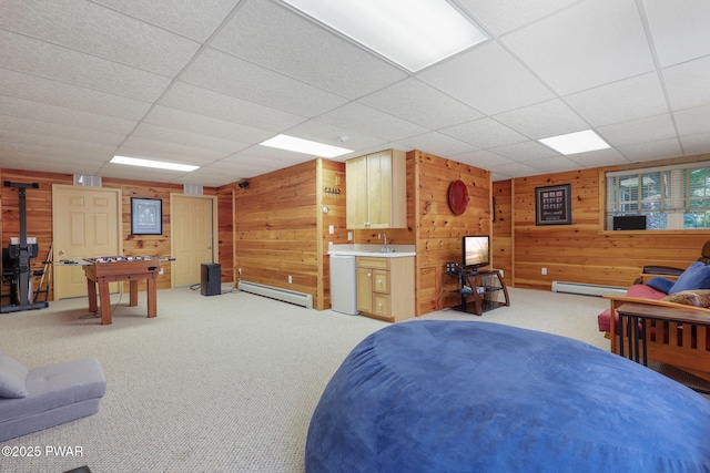 58 Rude Rd, Waymart, PA 18472 - bedroom featuring a baseboard heating unit, wooden walls, light colored carpet, a drop ceiling, and refrigerator